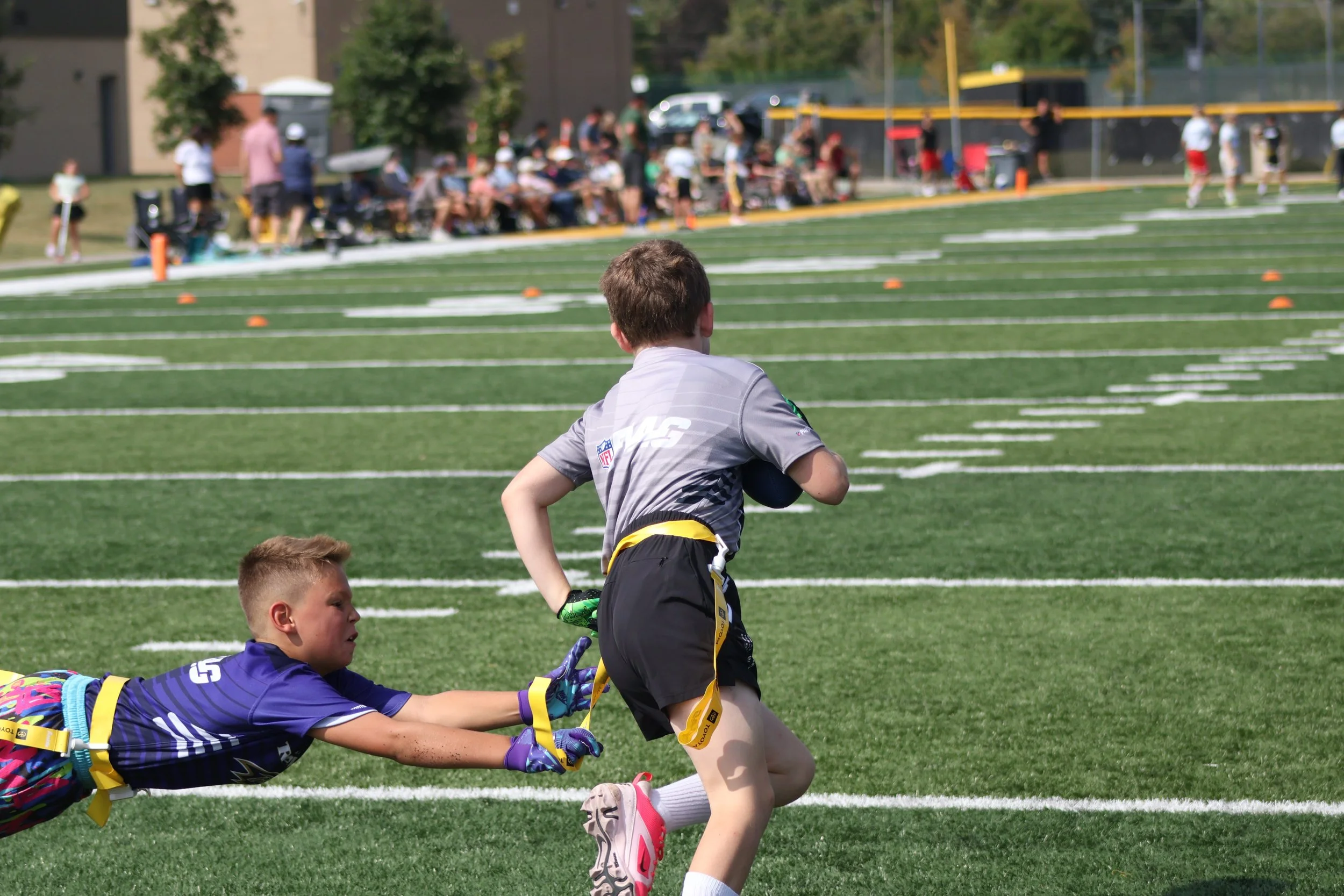 a young athlete dives for a flag playing NFL flag football with sunday funday sports in darien illinois