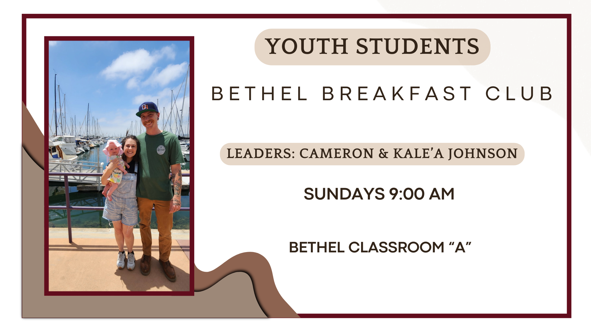 A family of three, with a woman holding a baby and a man, standing on a dock with boats and masts in the background, under a partly cloudy sky.