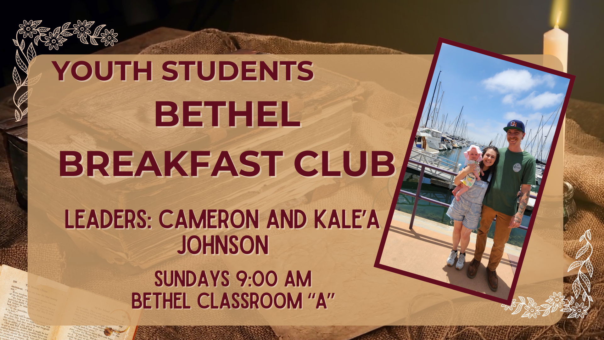 A family of three, with a woman holding a baby and a man, standing on a dock with boats and masts in the background, under a partly cloudy sky.