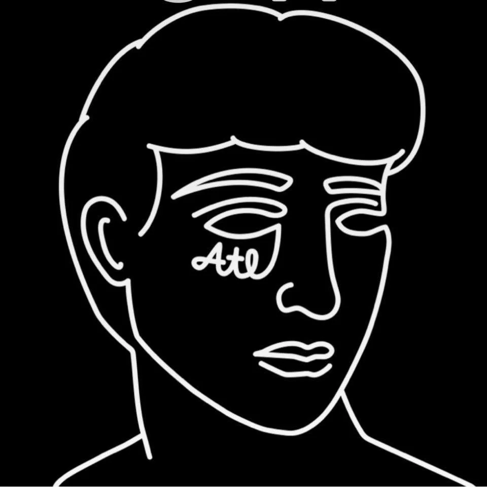 Neon line art of a man's face with the word 'Ato' on the cheek, black background.
