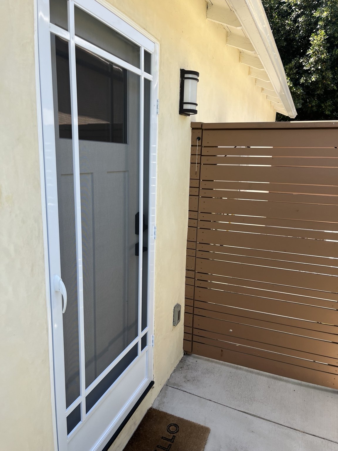 White custom screen door installed at a Southern California home