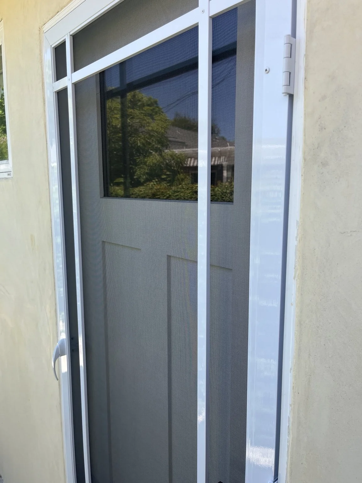 Close-up of a white custom screen door and mesh installation