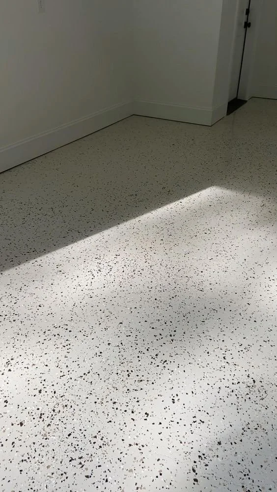 Light neutral epoxy flake garage floor with a smooth, easy-to-clean finish in Newport Beach, Orange County, CA. ZHLA Painting.