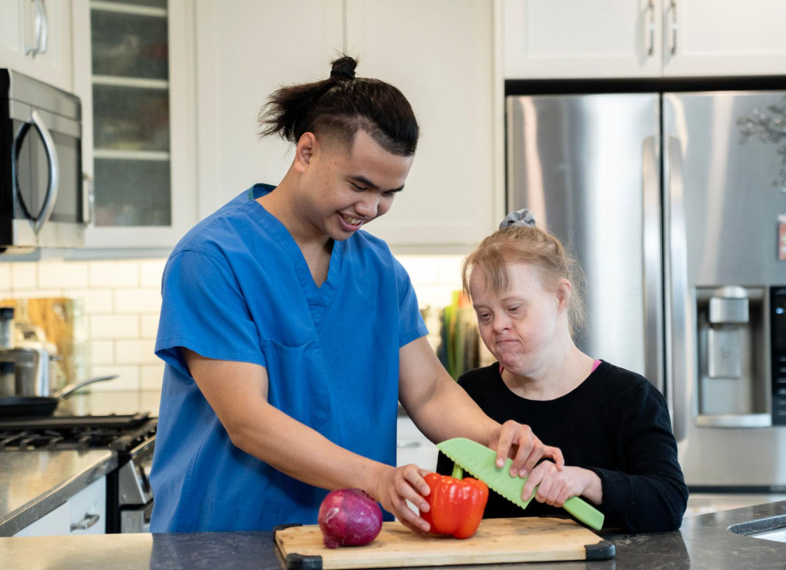 Individual participating in meal preparation with support