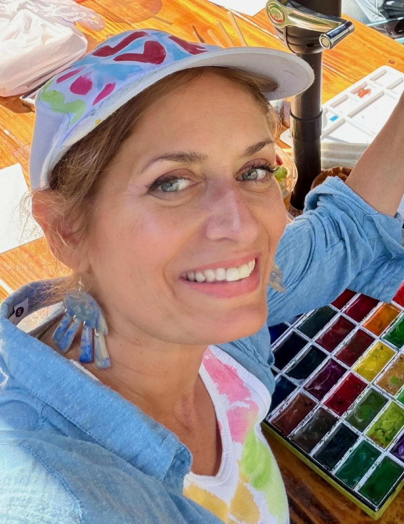 Photo of the artist, Marcy Morris in the act of painting with watercolor