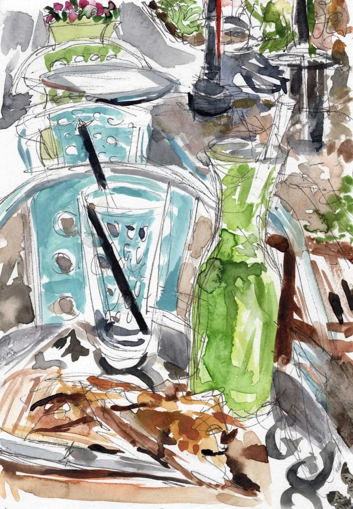 A Pitcher of Green mint lemonade & a plate of baklava on a table adjacent a metal chair at the Blue Fig Cafe