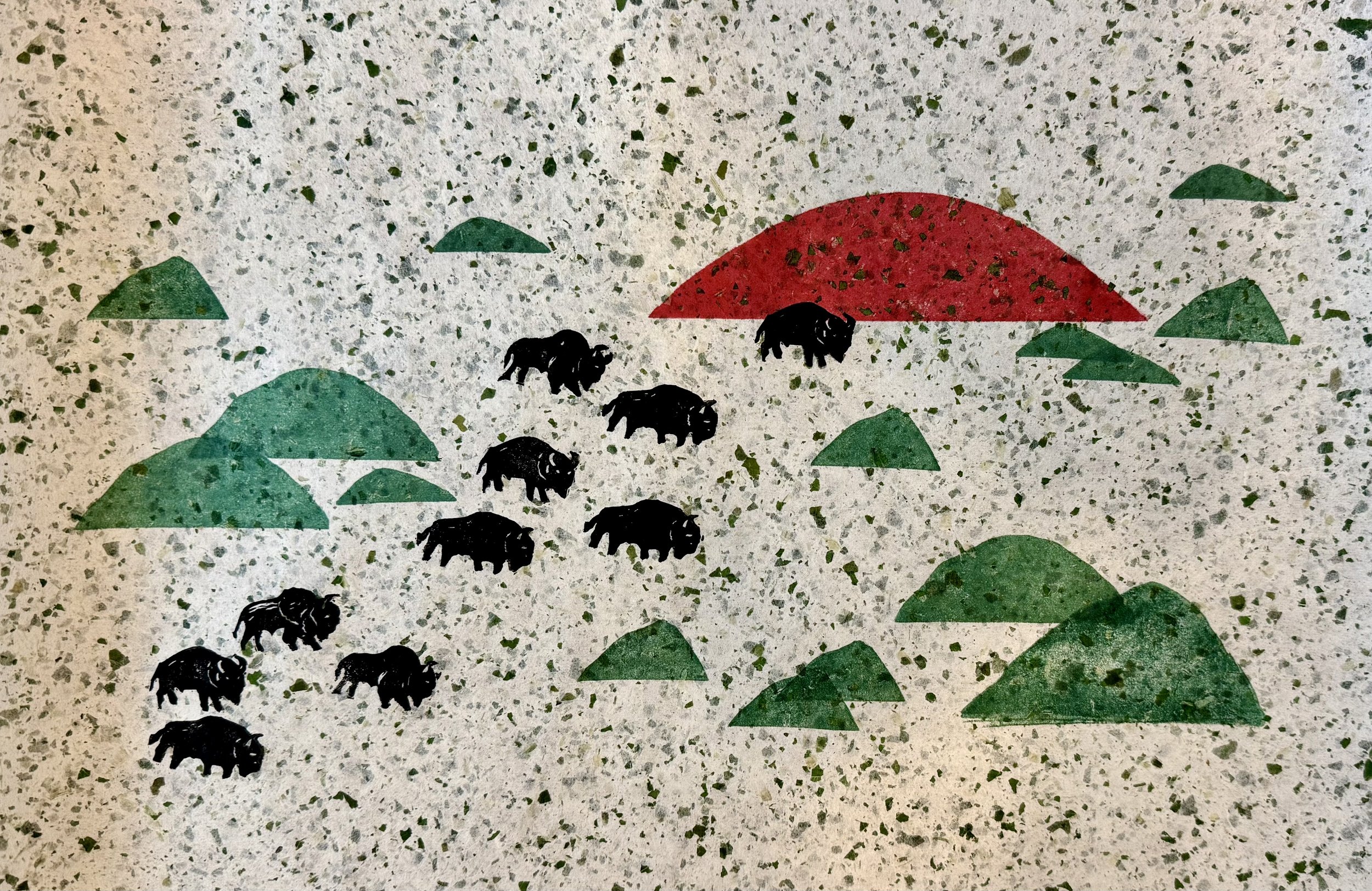 Graphic design of six black bison silhouettes walking among green hills and a red sun on a speckled gray background.