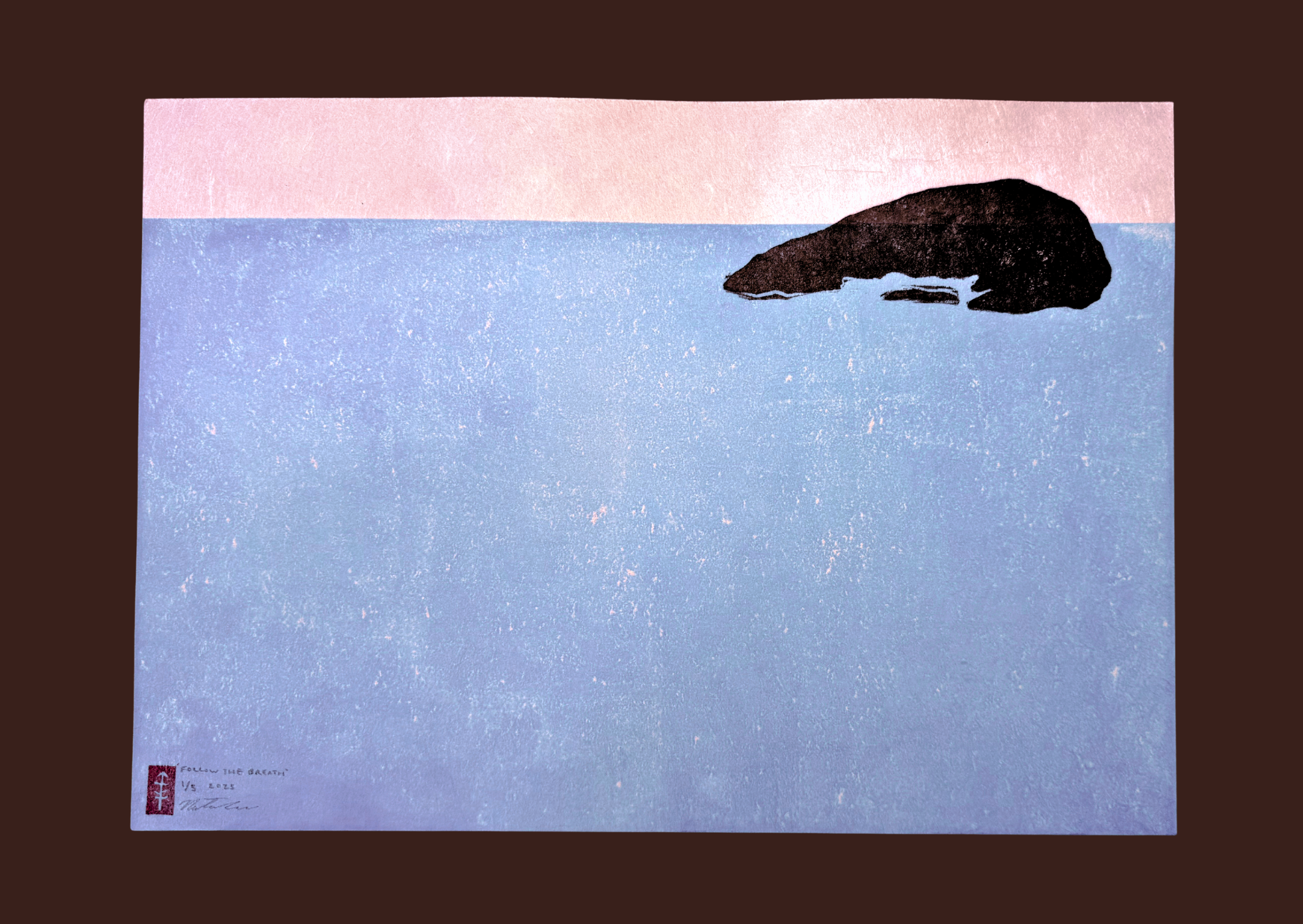 A minimalist painting of a large black rock in the water with a pink sky above and a brown border around the image.