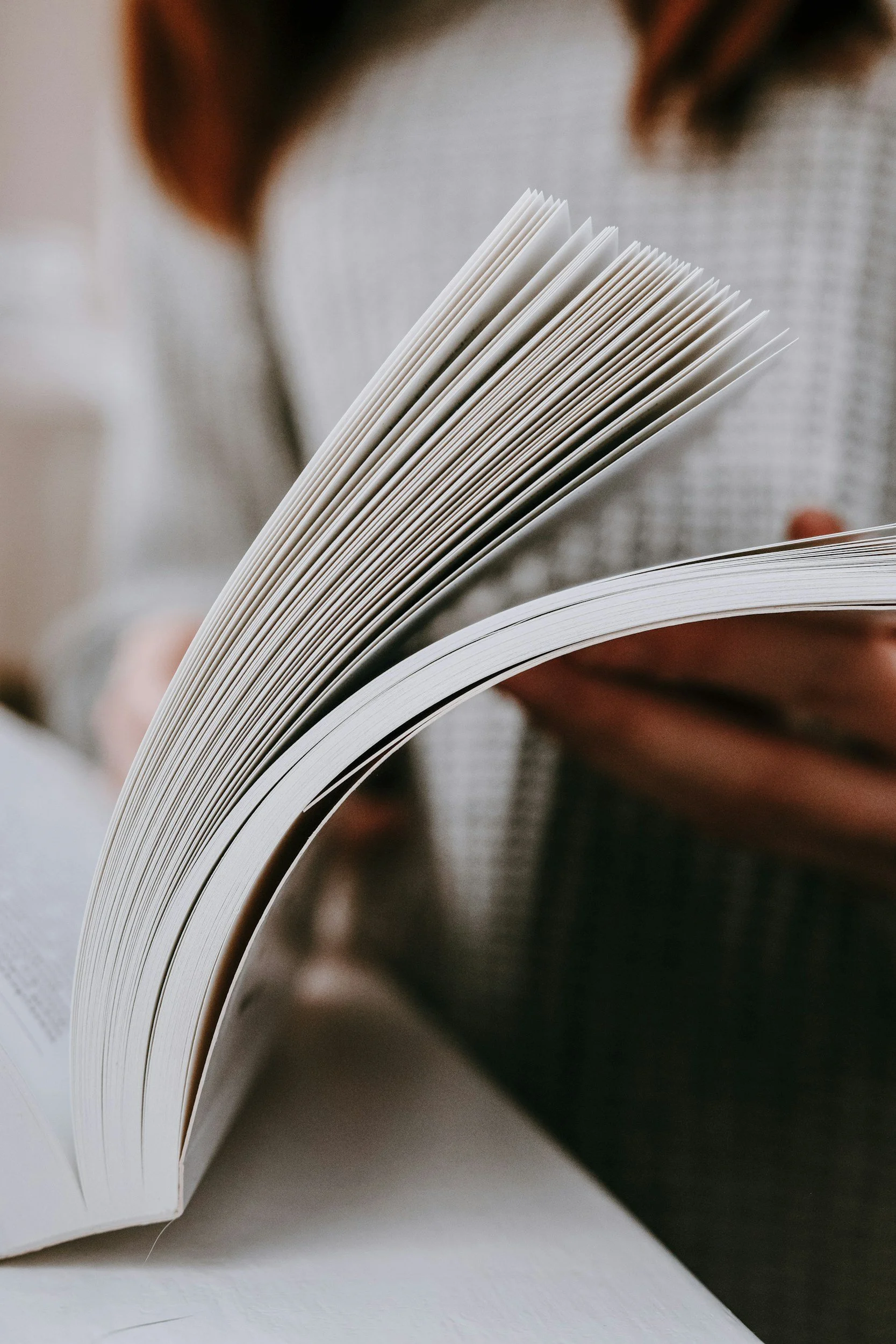 Person flipping through pages of a book.