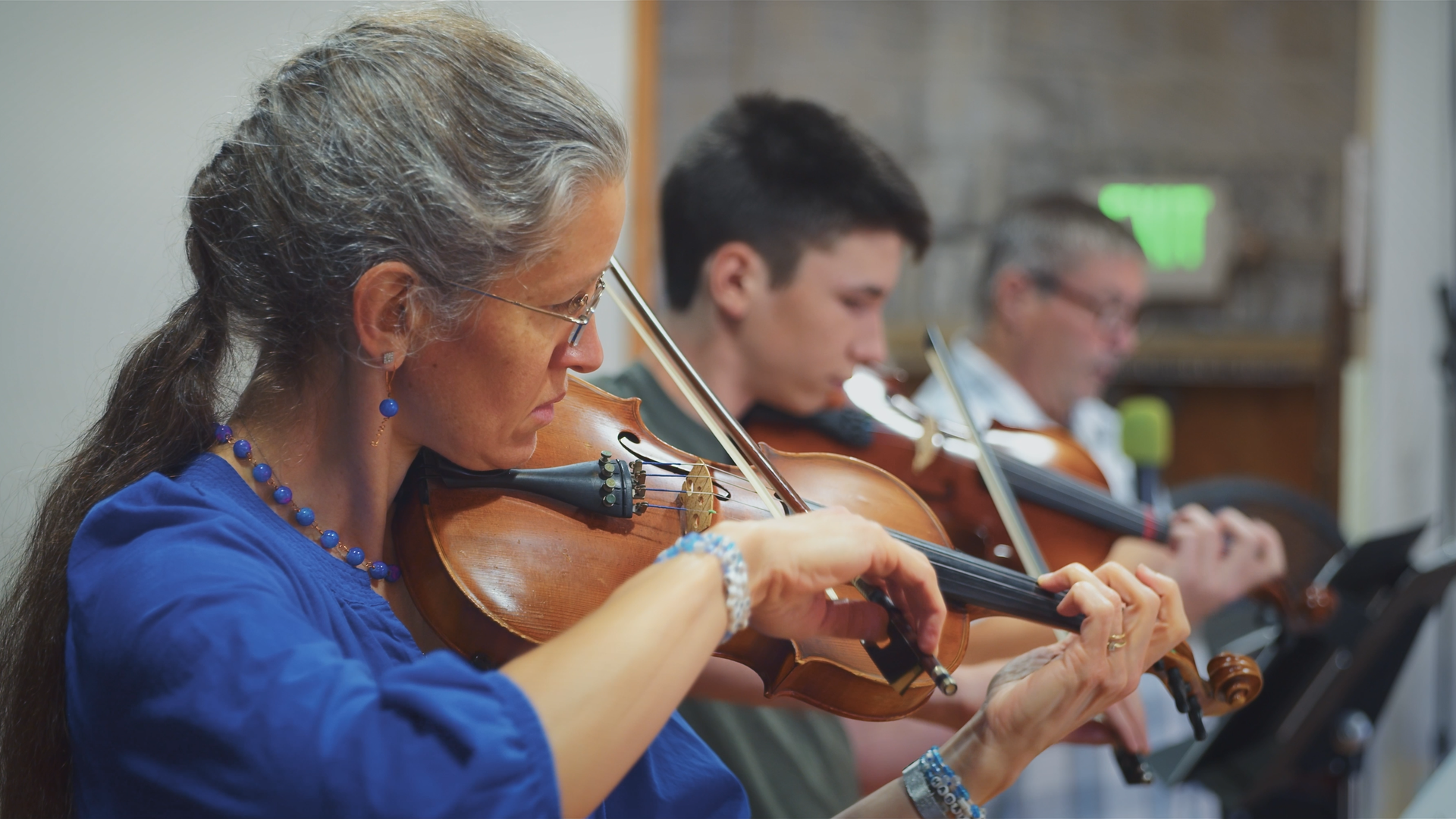 Musicians playing violins during a church service.