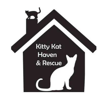 Logo for Kitty Kat Haven & Rescue featuring a house outline with a black cat sitting at the top of the chimney and a white cat silhouette inside the house.