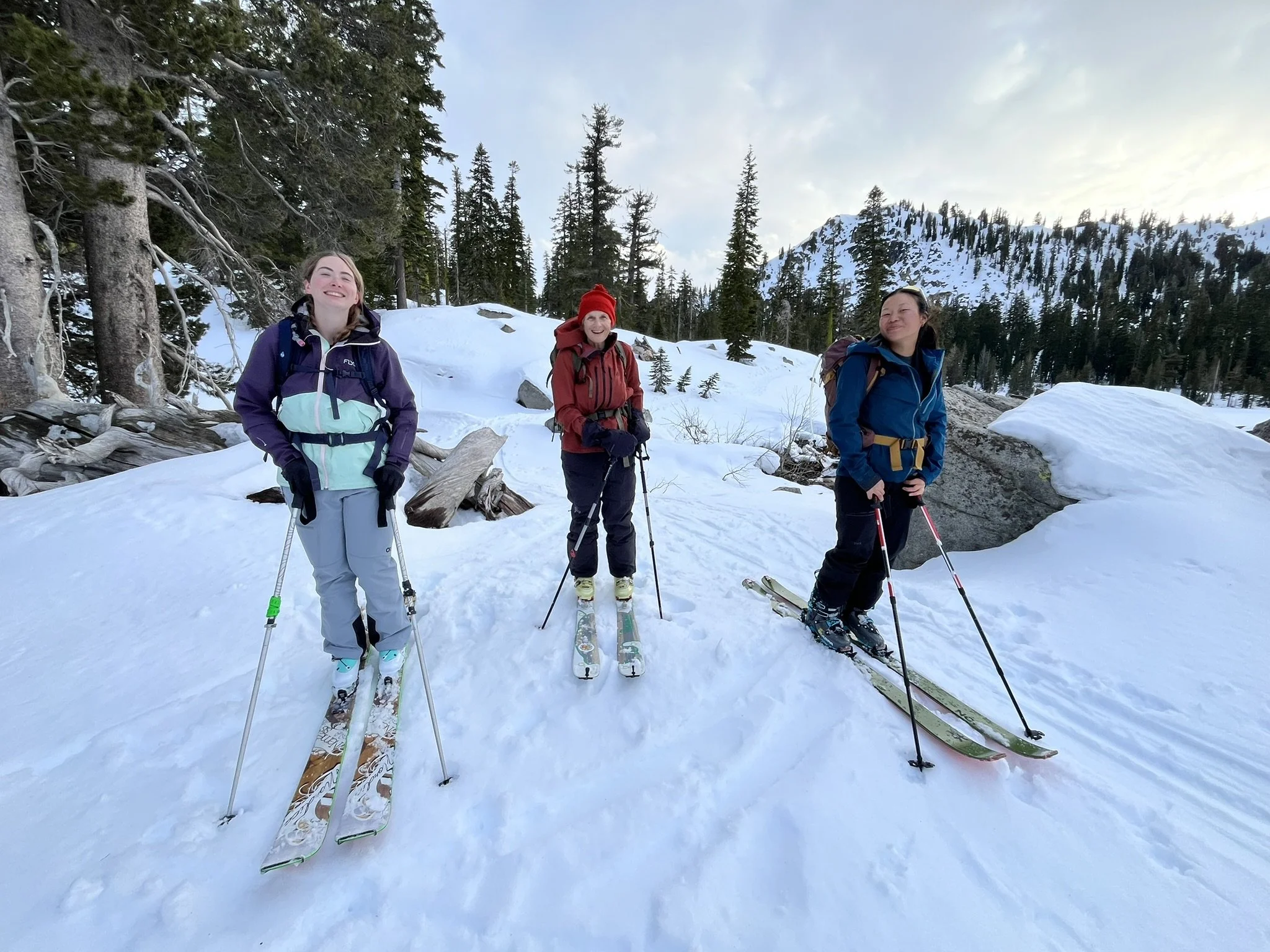 THREE WOMEN SKIING backcountry skiing