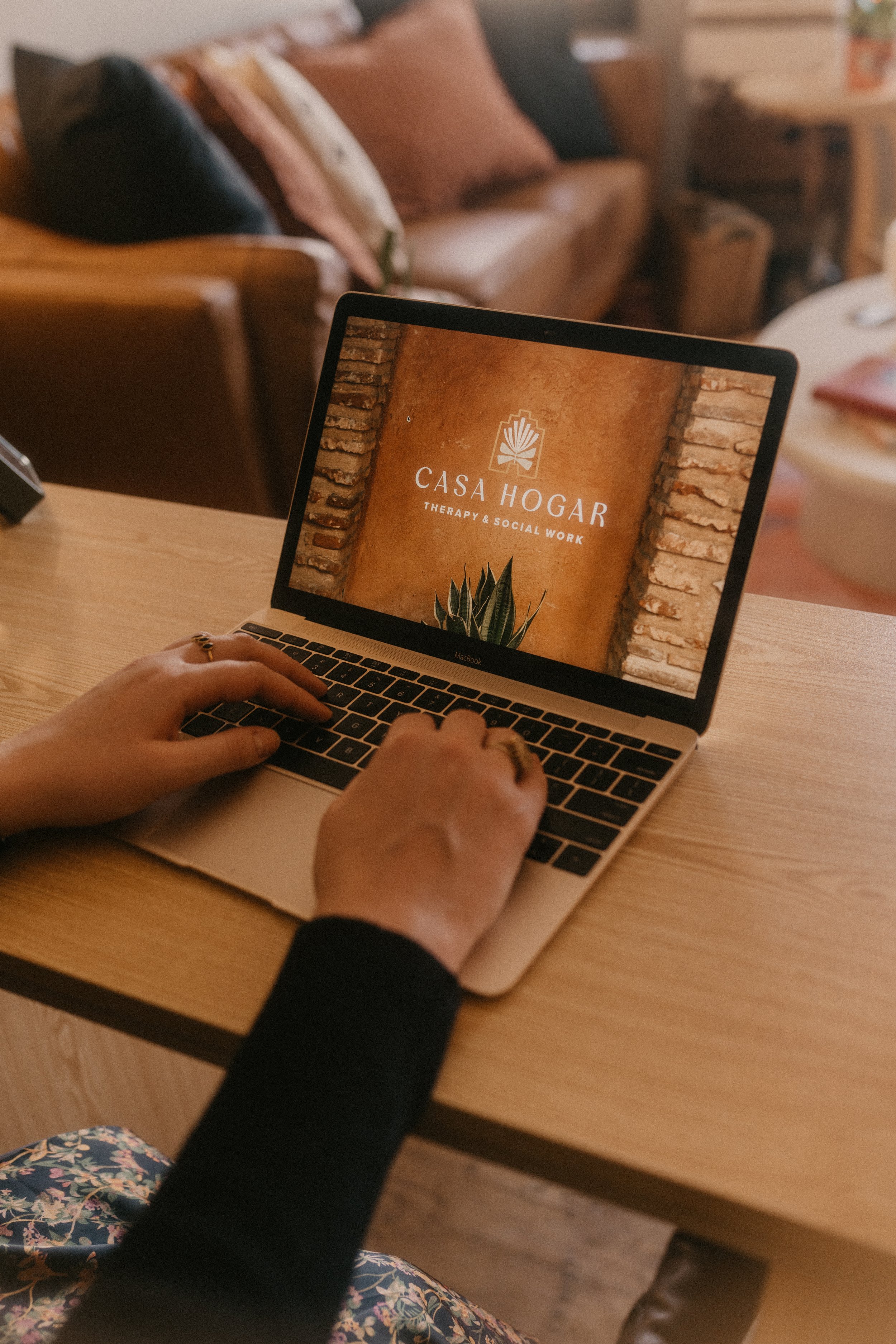 madeline types on computer at desk in Casa Hogar office