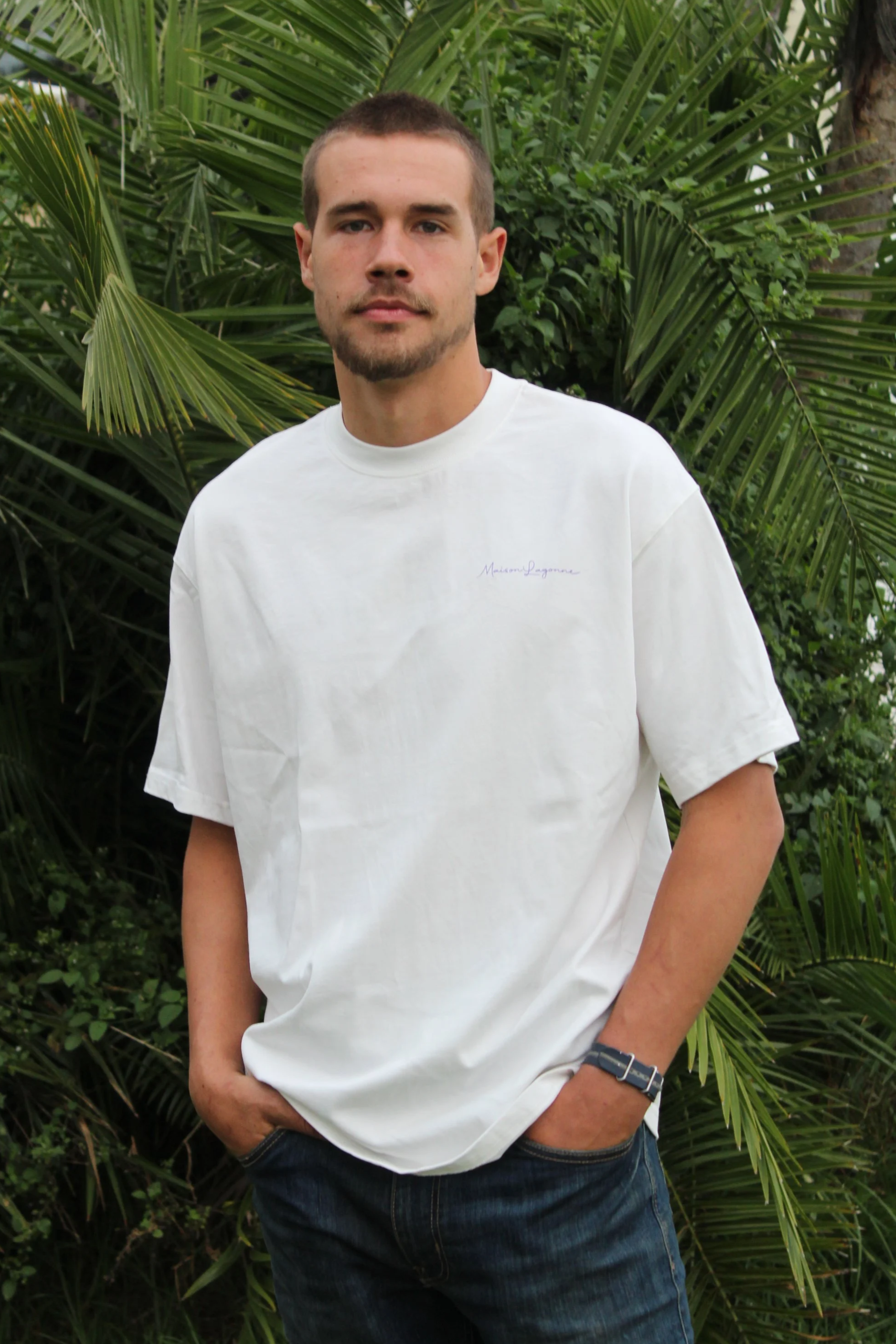 White oversized t-shirt styled in a natural  outdoor setting.