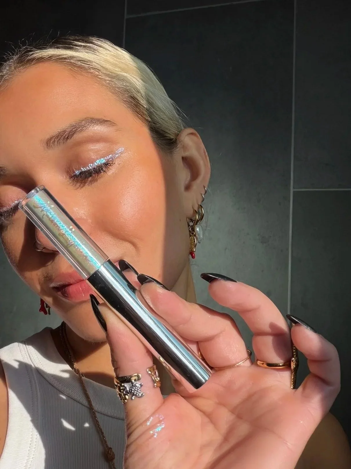 Color-shifting eyeliner catching the light in a soft, luminous finish.