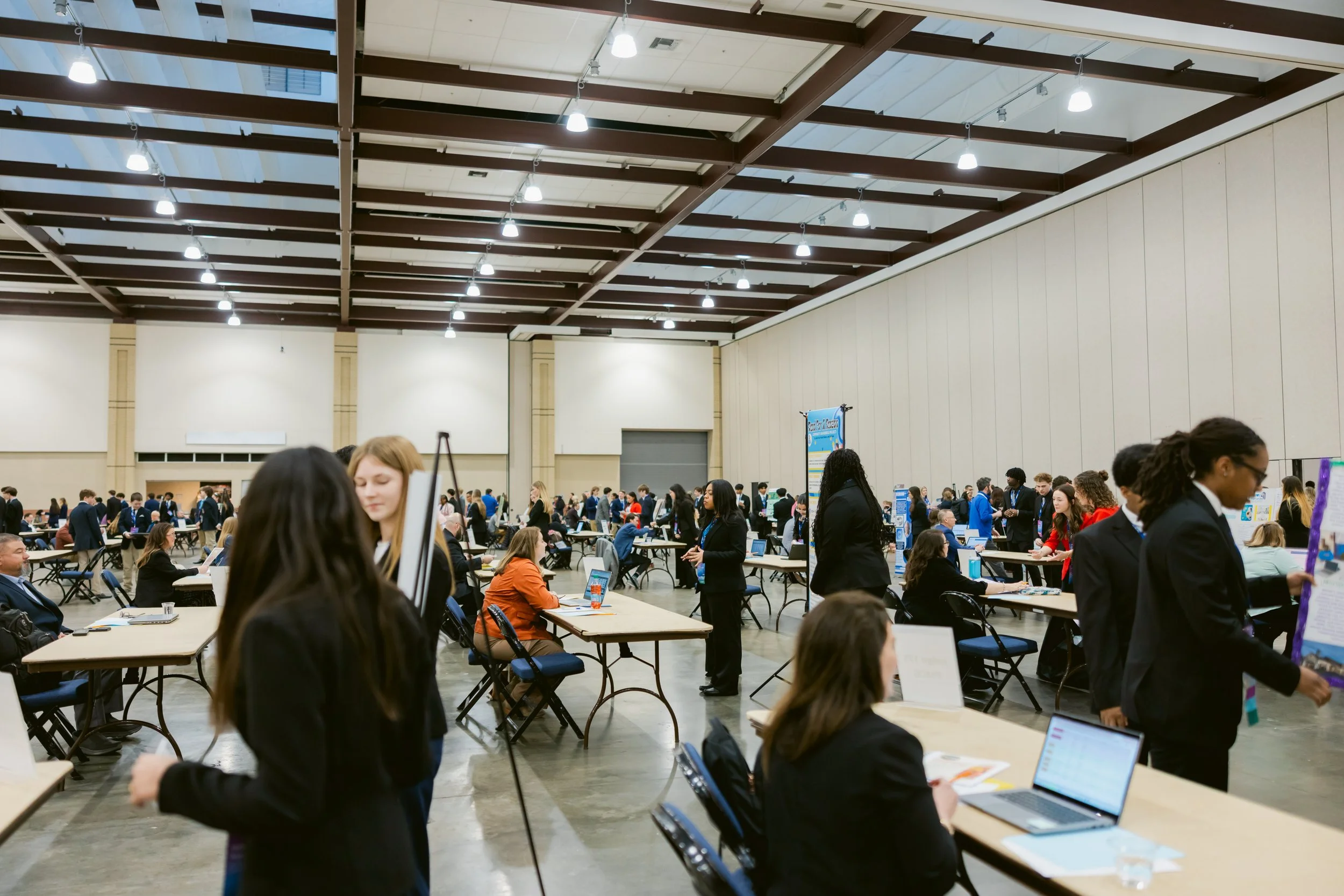 A DECA member participates in a role play competitive event with a volunteer judge.