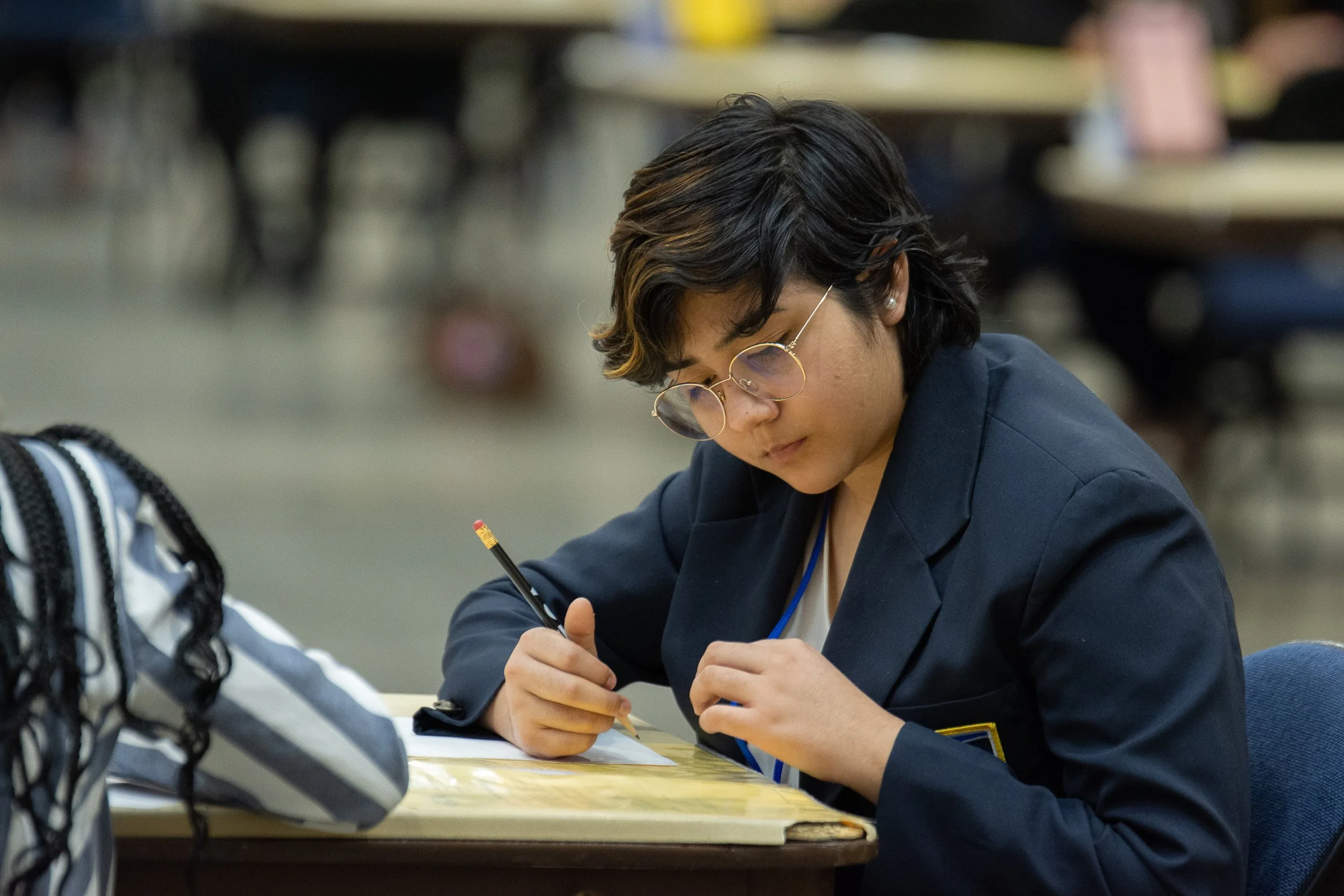 A competitor writes on paper as they complete the planning portion of their competitive event.