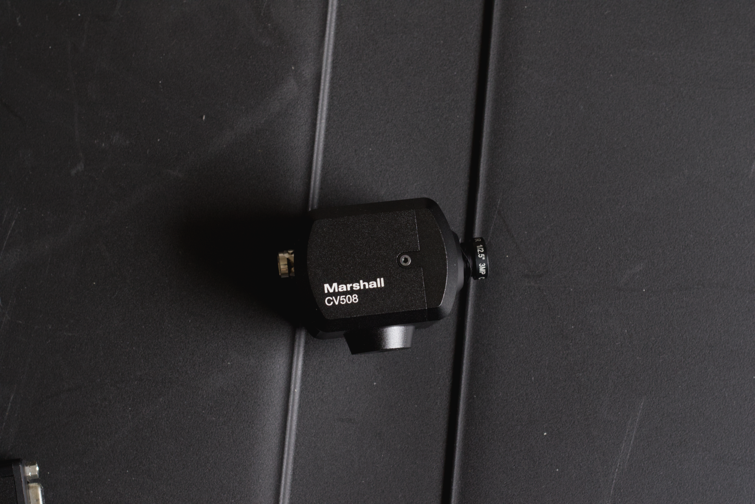 A black Marshall CV508 wireless microphone receiver mounted on a black wall or panel.
