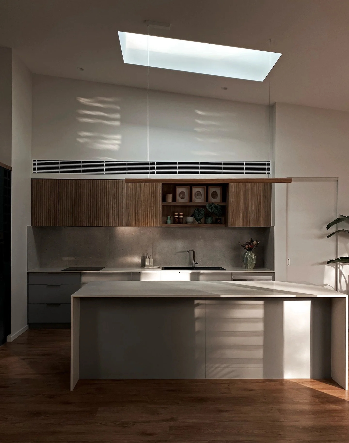 That first morning light on stone, timber &amp; textured finishes.
Designed to feel calm, grounded &amp; connected 🫶🏼
Build @pirret.constructions 

~ Upper cabinetry: Prime Oak thermolaminate by @polytec 
~ Lower cabinetry: Pewter AbsoluteMatt by @