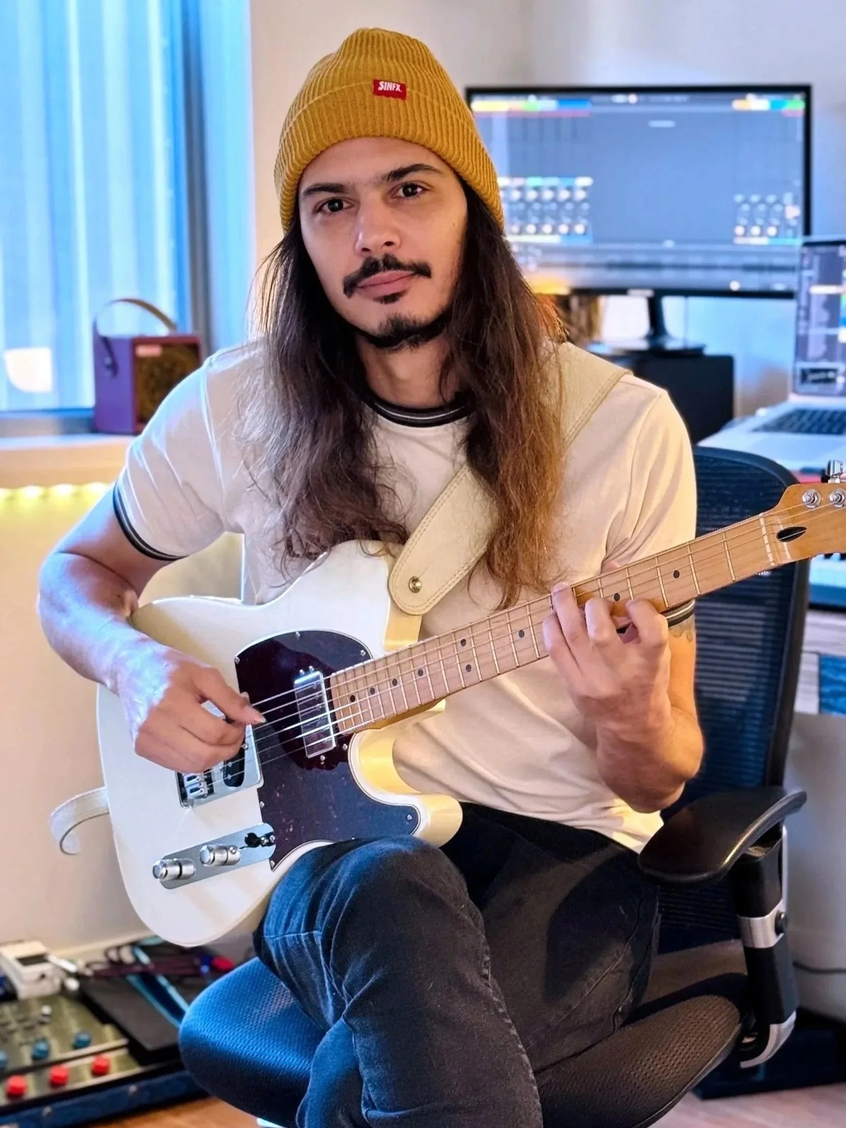 Bruno Yagüe playing electric guitar in his Dee Why music studio