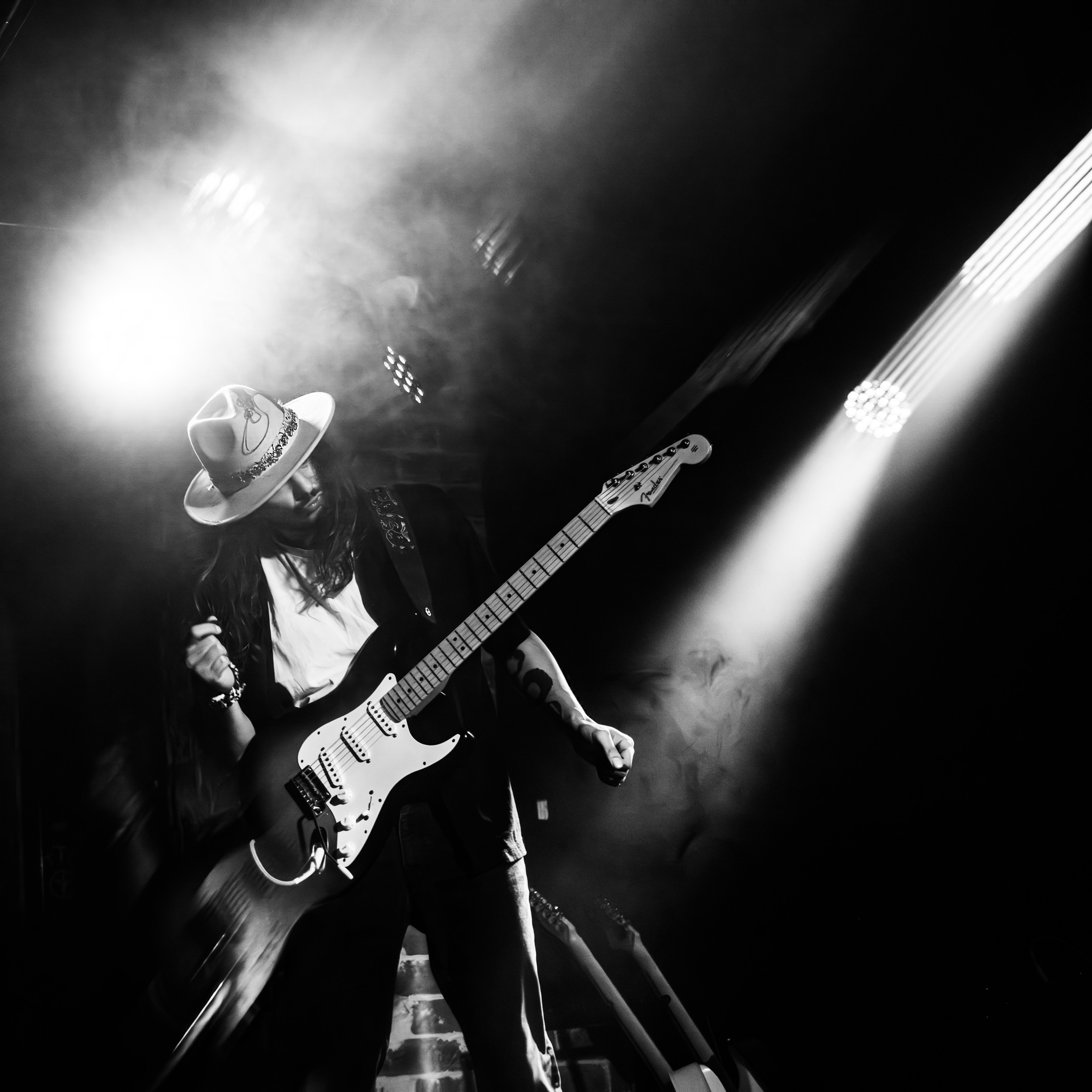 Bruno Yagüe performing on electric guitar in black and white
