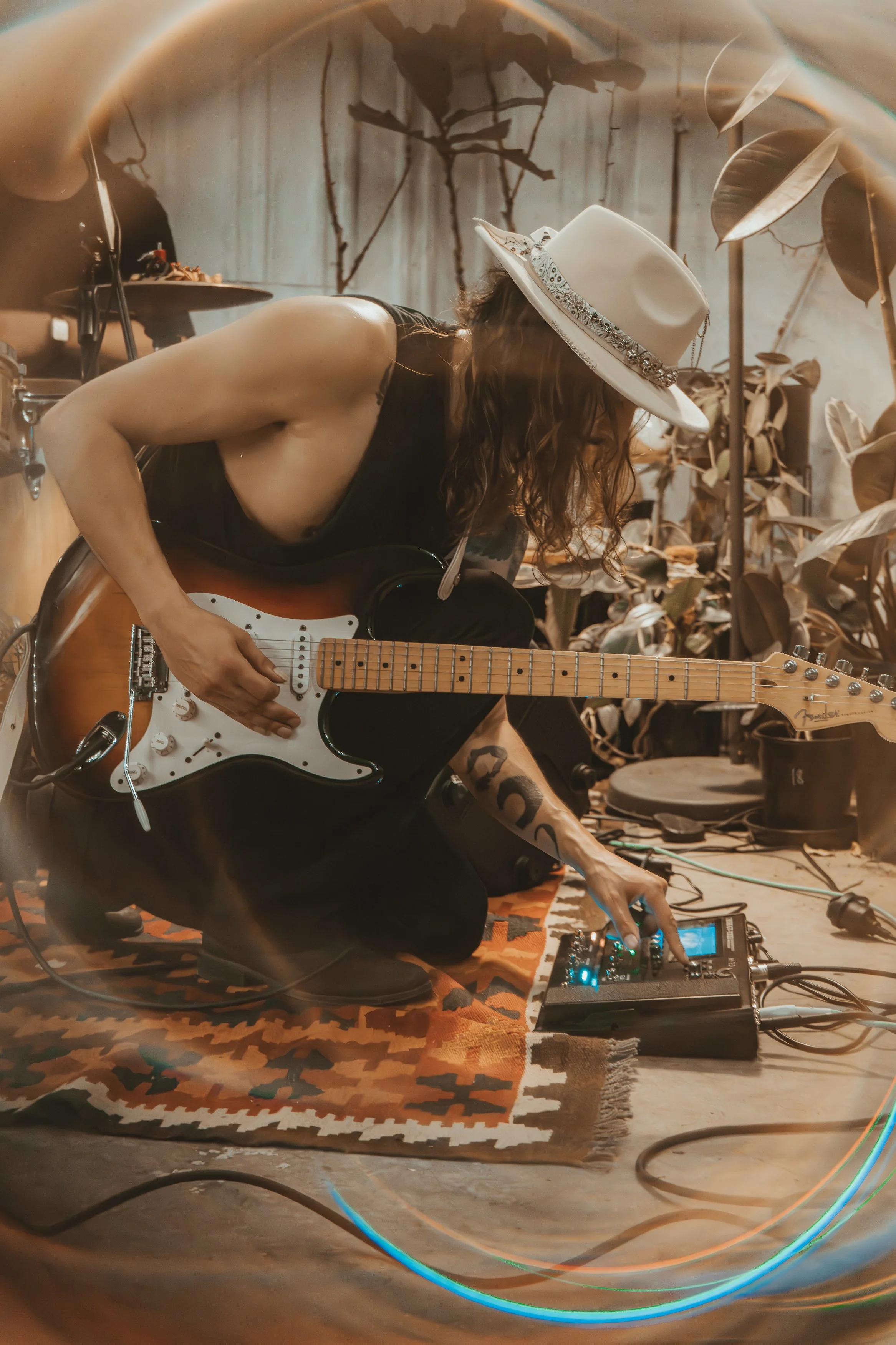 Bruno Yagüe playing electric guitar and using effects pedals during a live performance