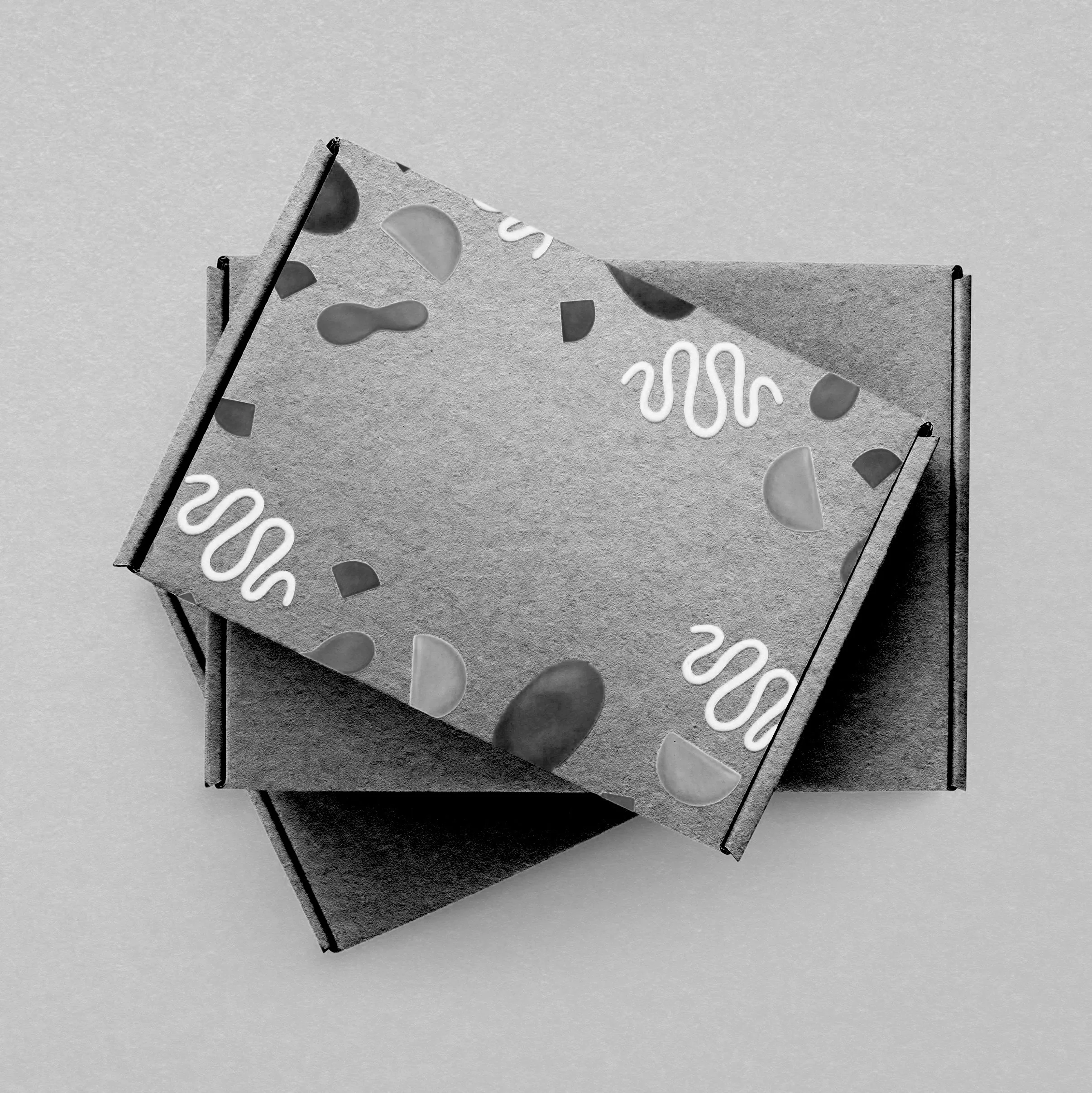A closed decorative cardboard box with abstract patterns, placed on a flat surface.
