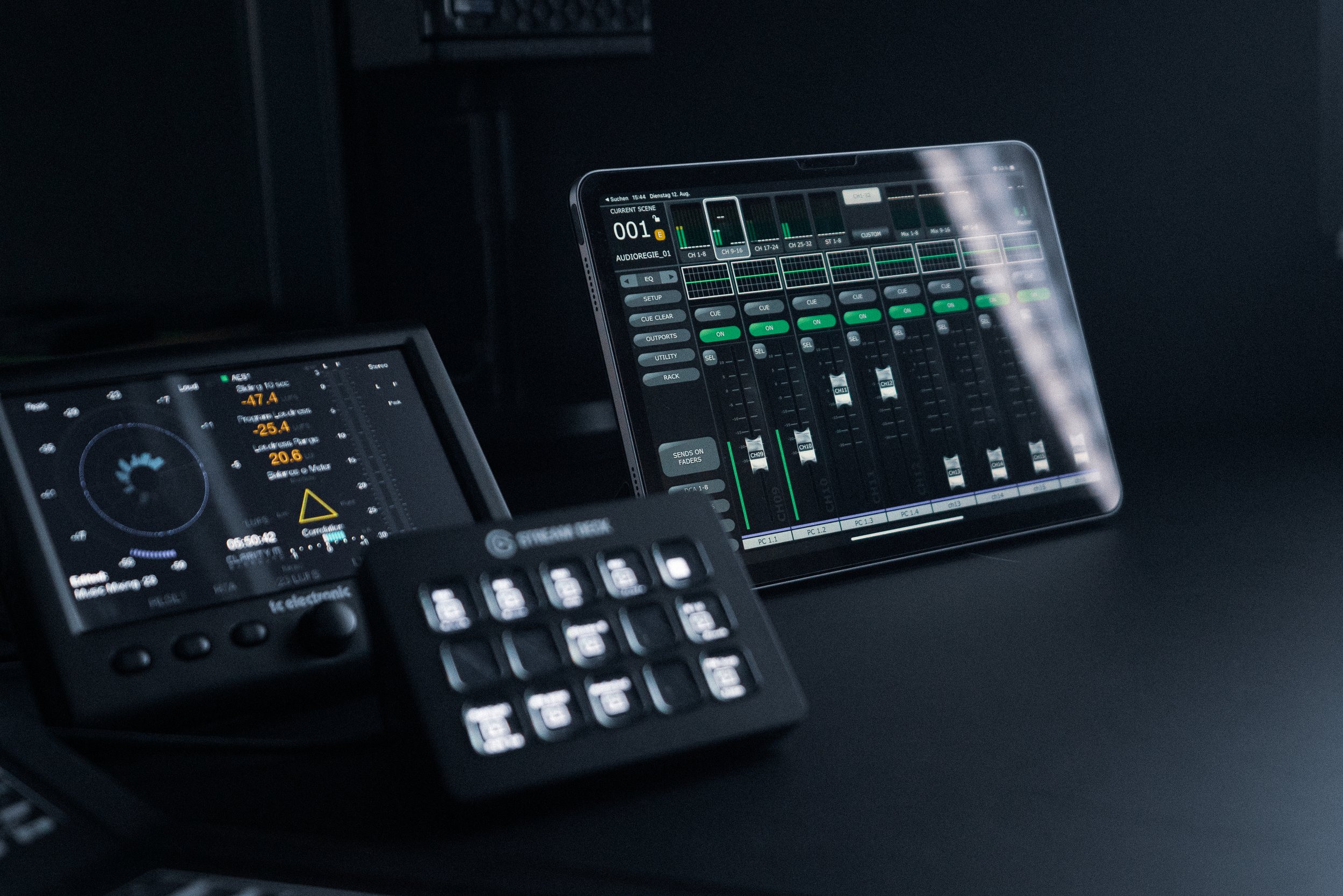 Audio mixing equipment including a digital audio workstation on a tablet, a control surface, and a DJ controller.