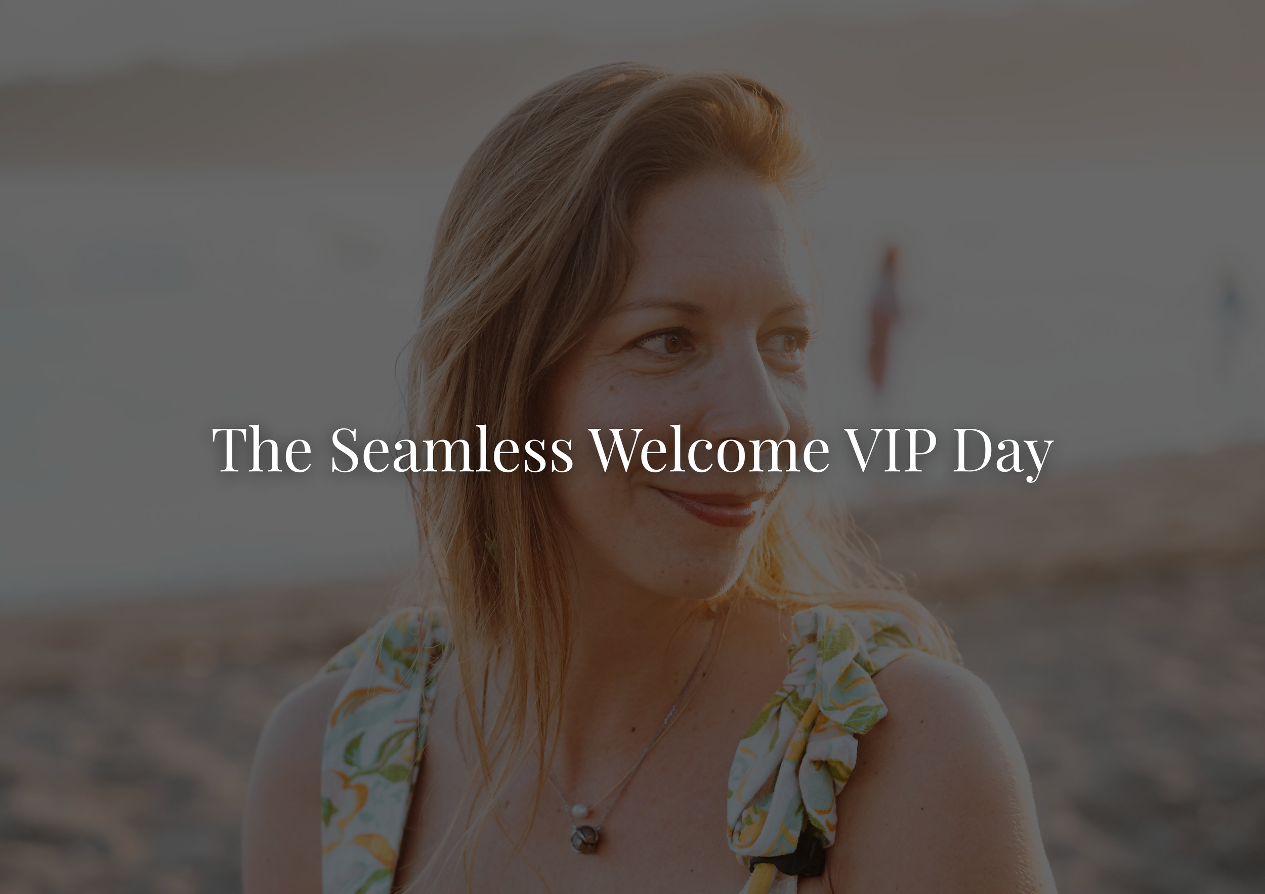 A woman with reddish hair smiling on a beach during sunset, with the text "The Seamless Welcome VIP Day" overlayed.