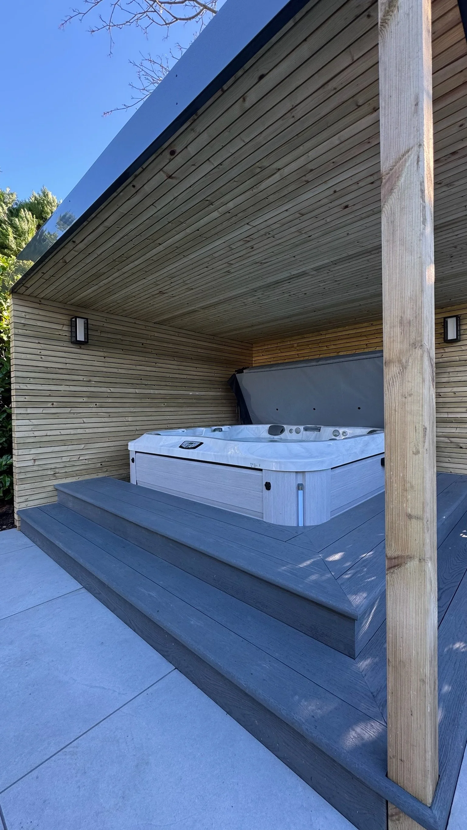 Outdoor hot tub on a wooden deck & pergola. Esme is a garden design & landscaping company serving surrey, hampshire, berkshire, camberley, london & surrounding areas. We build bespoke outdoor living spaces with a hot tub, swim spas and more. 