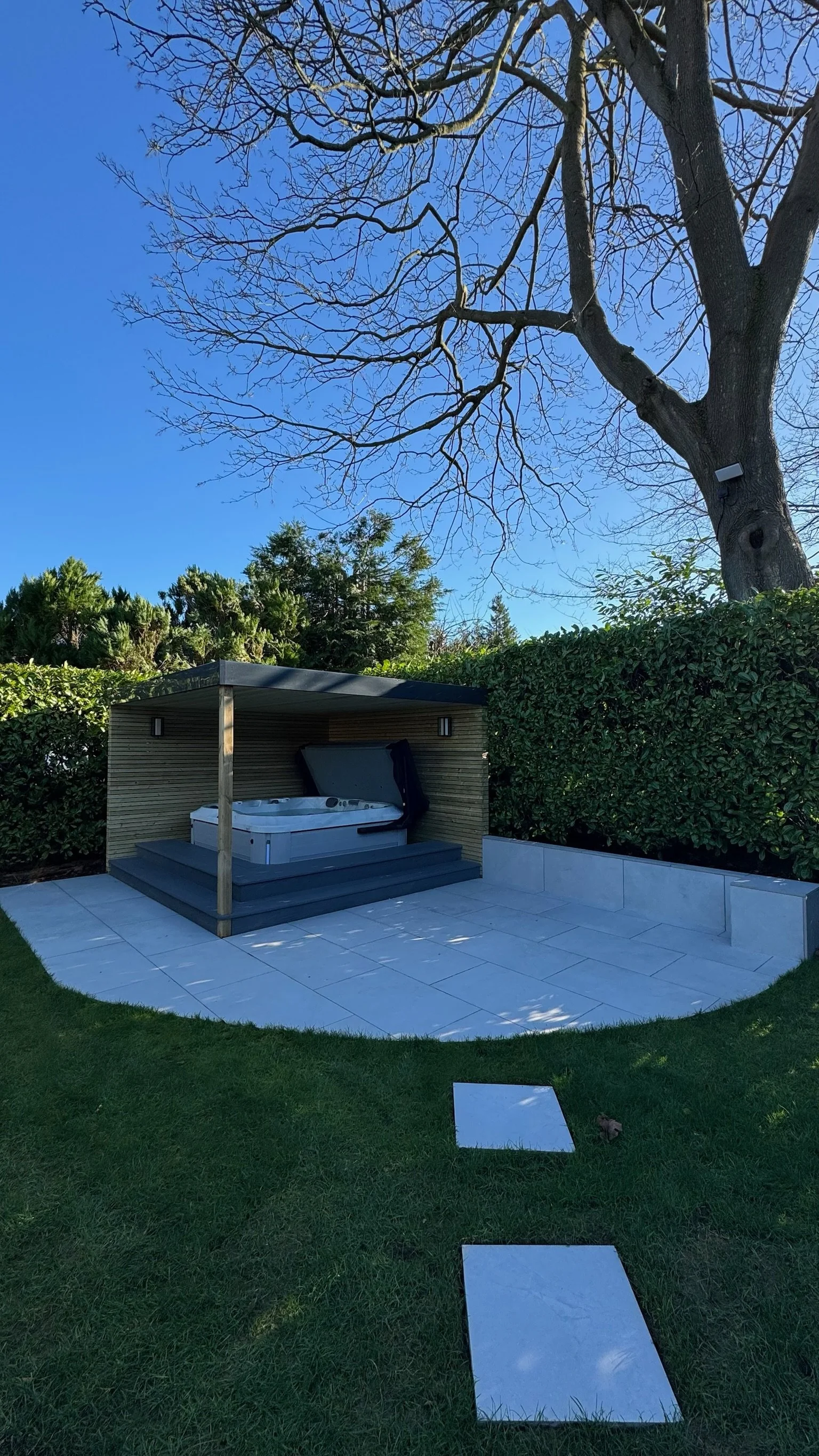 Outdoor wooden cabana with hot tub. Esme is a garden design & landscaping company serving surrey, hampshire, berkshire, camberley, london & surrounding areas. We build bespoke outdoor living spaces with a hot tub, swim spas, outdoor kitchens, pergola