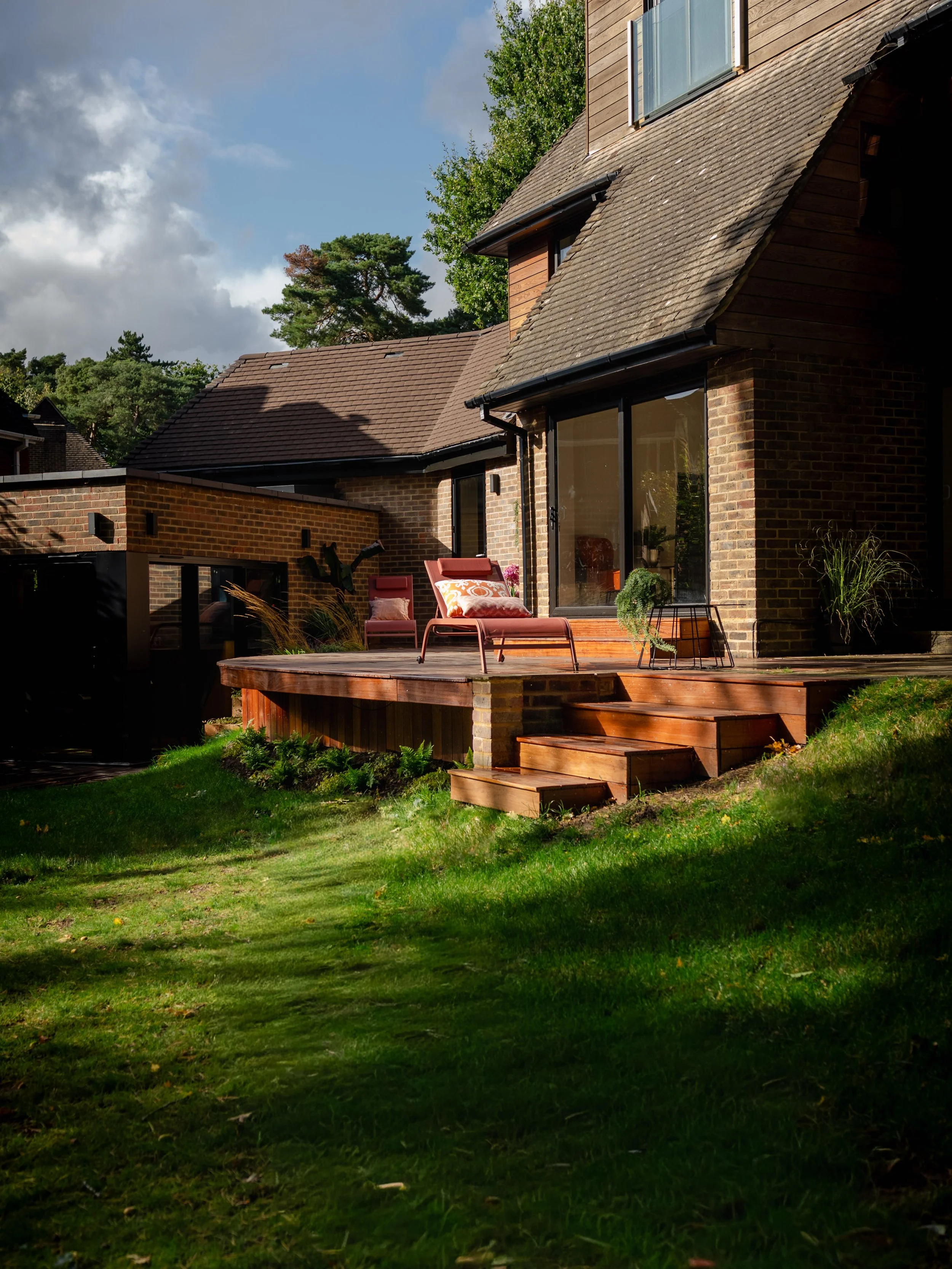 Wooden decking in this garden with potted plants.  Esme are a widely trusted decking, garden design and landscaping company serving surrey, hampshire, berkshire, ascot, london and surrounding areas.