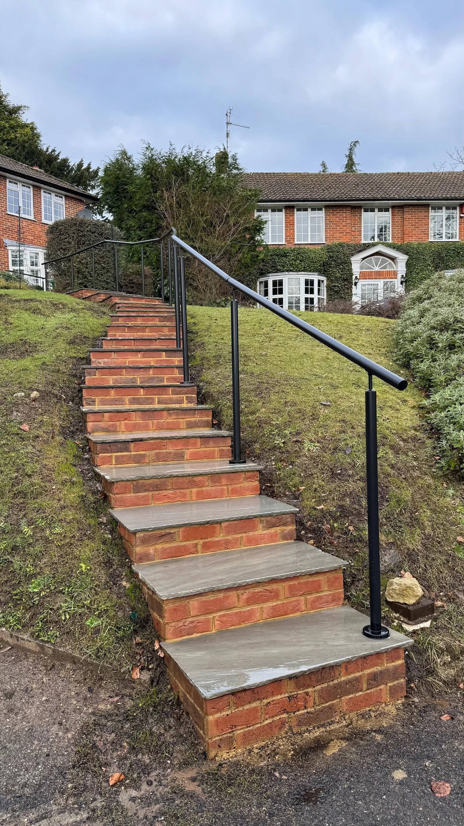 We built an outdoor brick staircase with a black metal handrail. Esme are a widely trusted garden design and landscaping company serving surrey, hampshire, berkshire, ascot, london and surrounding areas.
