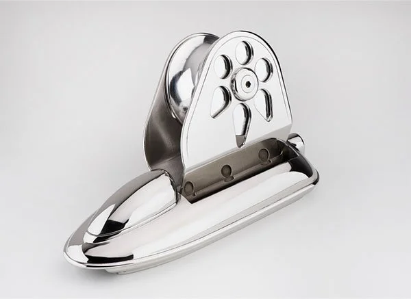 A chrome and black weighted apple corer with a built-in slicer.