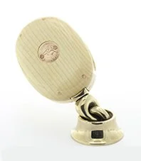 A wooden block with a metal bracket and a circular logo on the front.