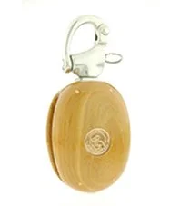 A wooden block with a metal bracket and a circular logo on the front.