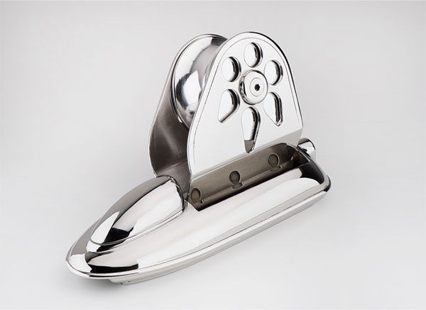 A chrome pencil sharpener with a sliding cover and a removable blade for sharpening pencils.