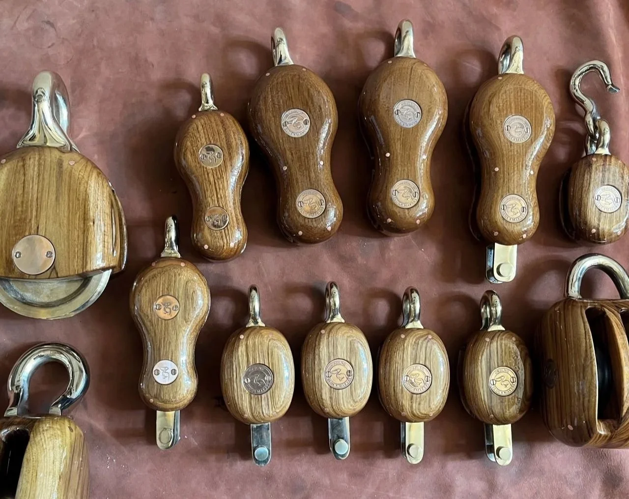 A collection of wooden blocks with metal fittings and decorative metal badges.