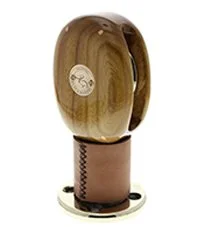 A wooden block with a metal bracket and a circular logo on the front.