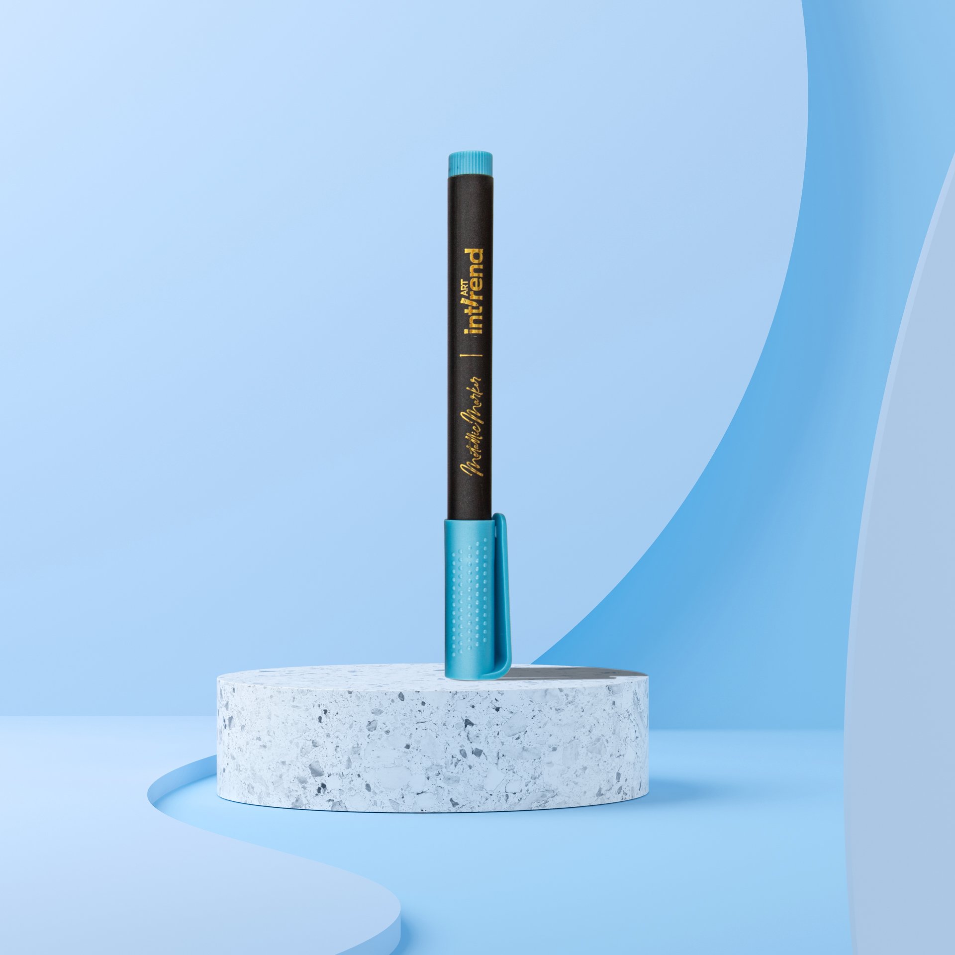 A black marker pen with a turquoise cap and grip, standing upright on a circular speckled concrete platform against a light blue background.