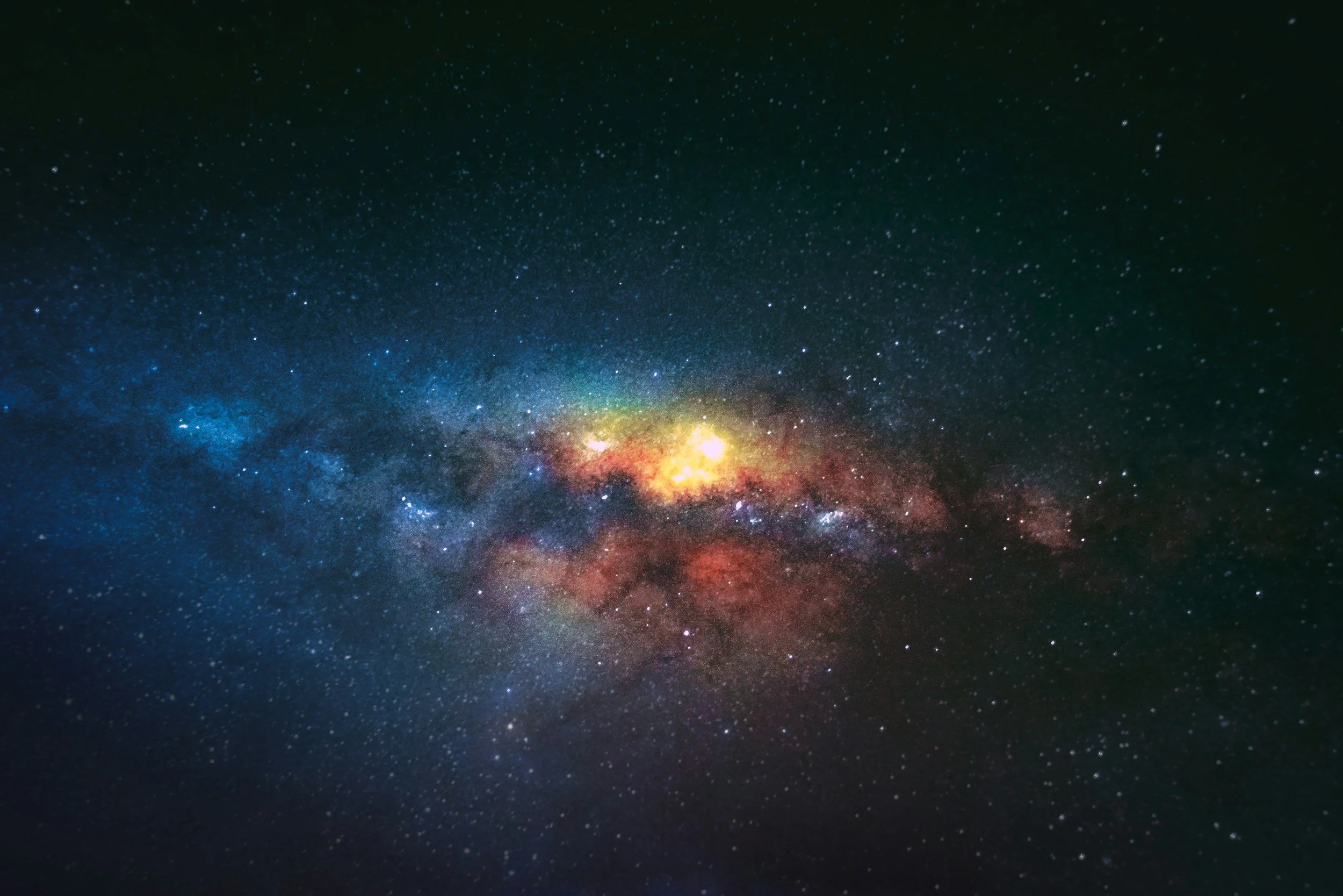 A view of the night sky showing numerous stars, nebulae, and the Milky Way galaxy with colorful cosmic dust clouds.