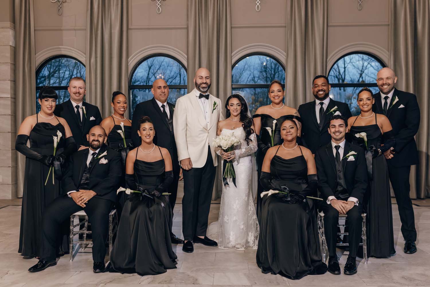 A wedding party poses in an upstate New York Ballroom