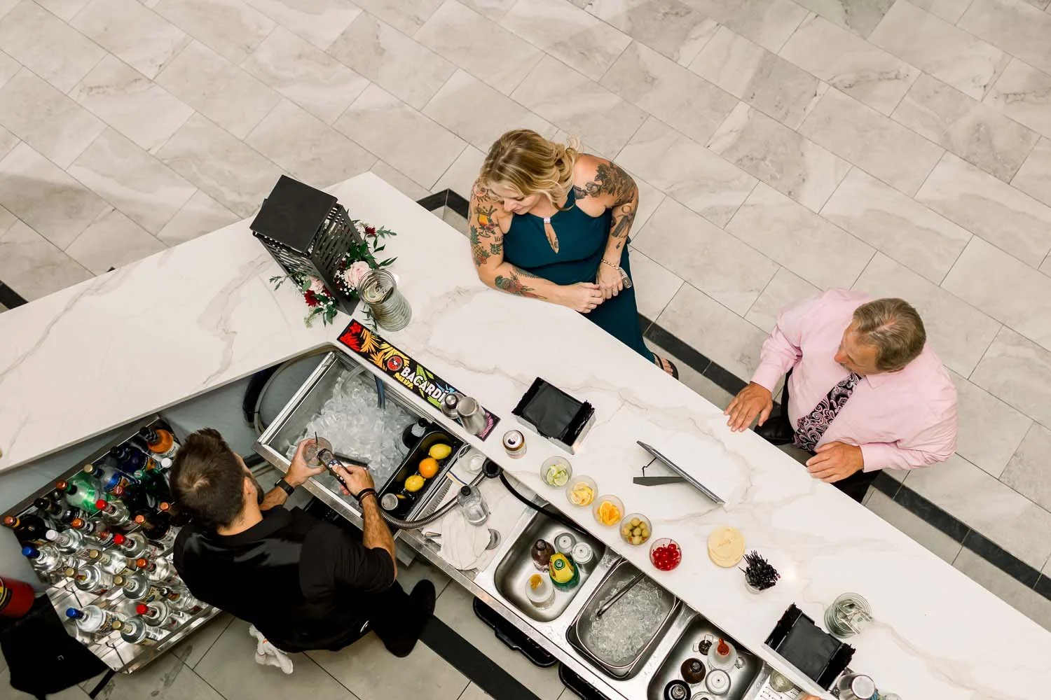 Modern overhead view of the luxury marble bar layout at a full-service wedding venue during cocktail hour.