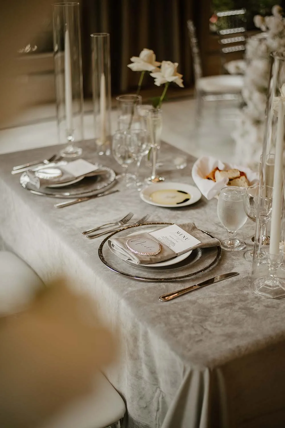 monochromatic table setting with silver velvet tablecloth