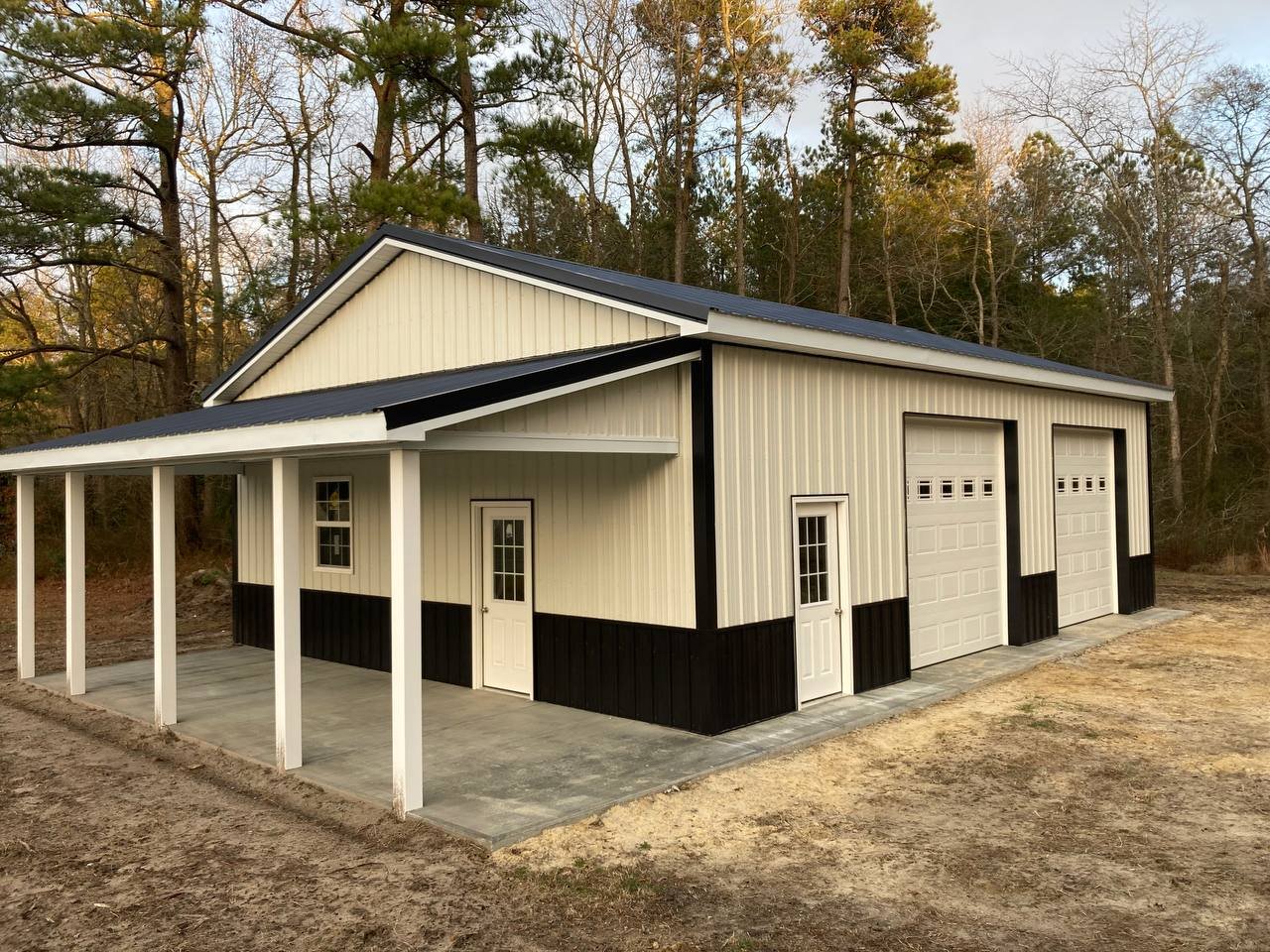Detached garage with metal siding and overhead doors