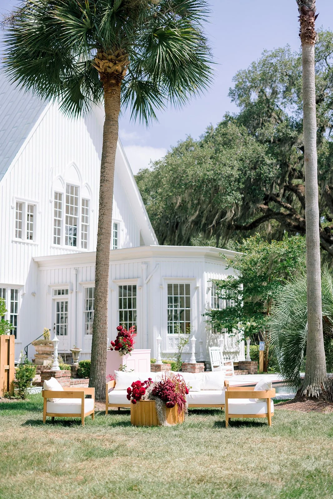 Cocktail hour seating featuring dramatic wedding flowers and Southern charm.