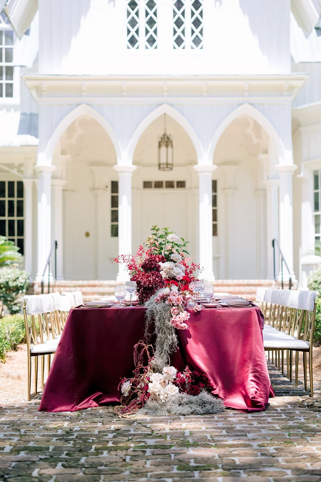 Romantic burgundy wedding centerpiece with cascading Spanish moss
