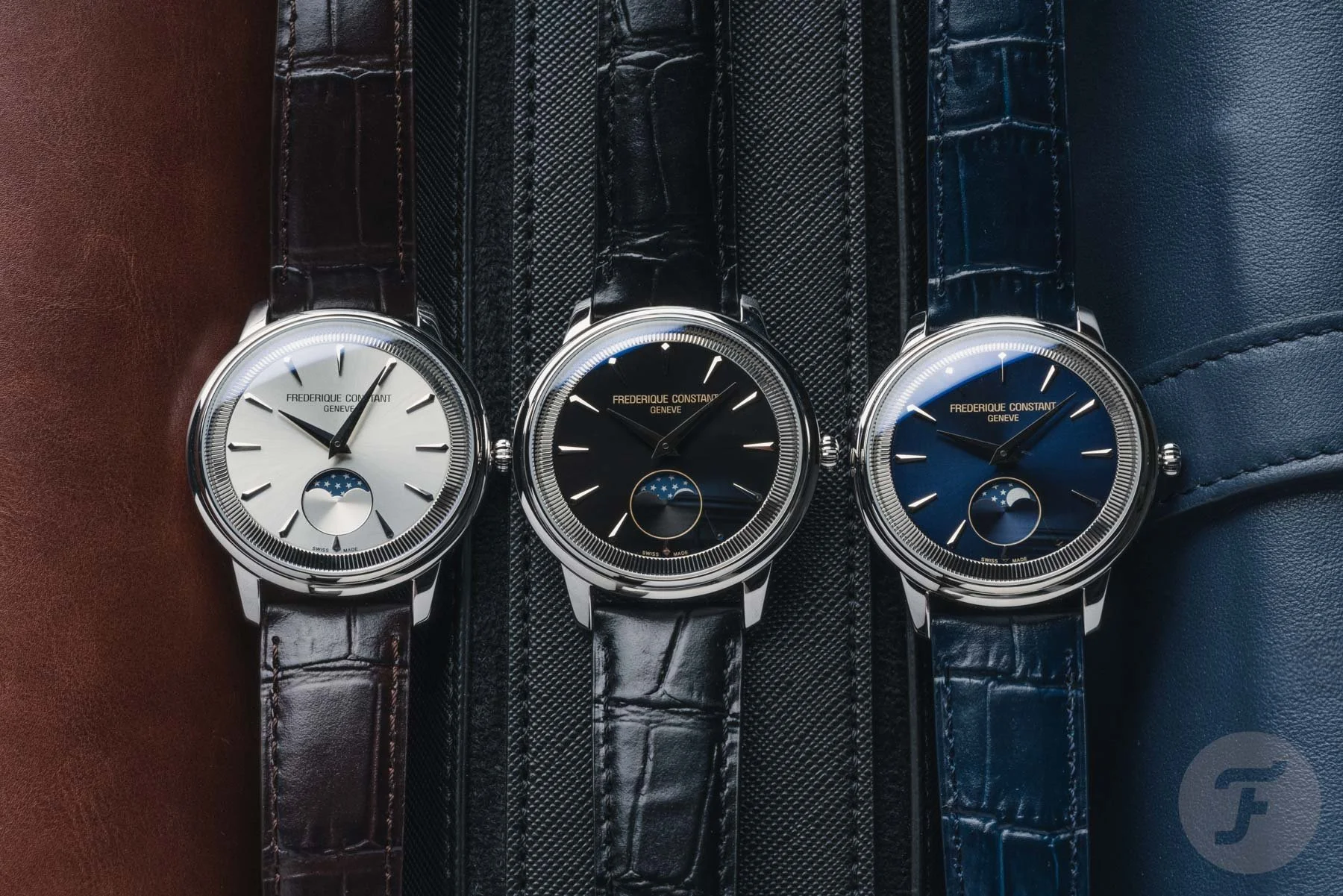 Three Frederique Constant Moneta Moonphase watches next to each other with different coloured dials.