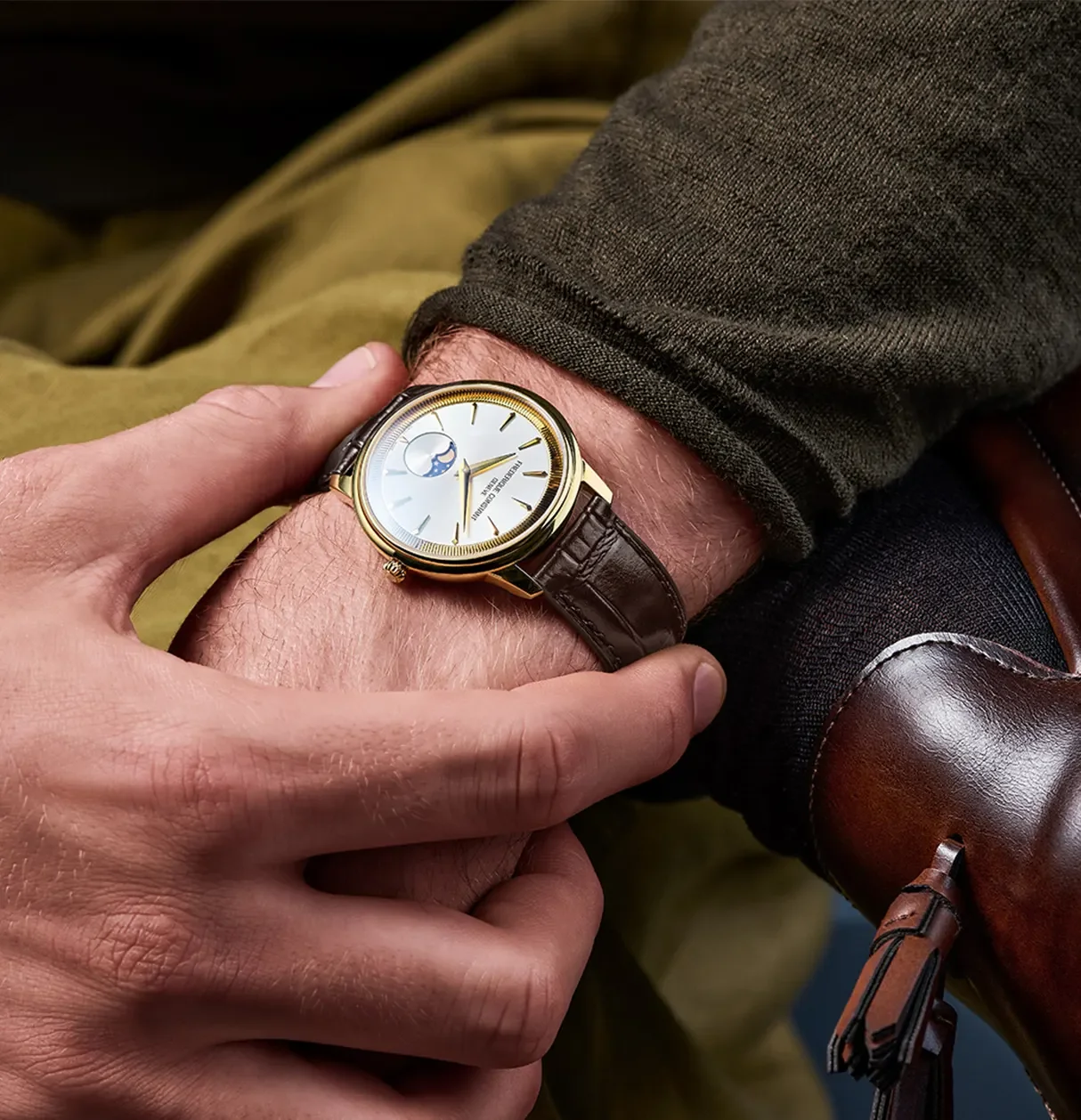 Yellow gold frederique Constant Moneta Moonphase watch on wrist of a man