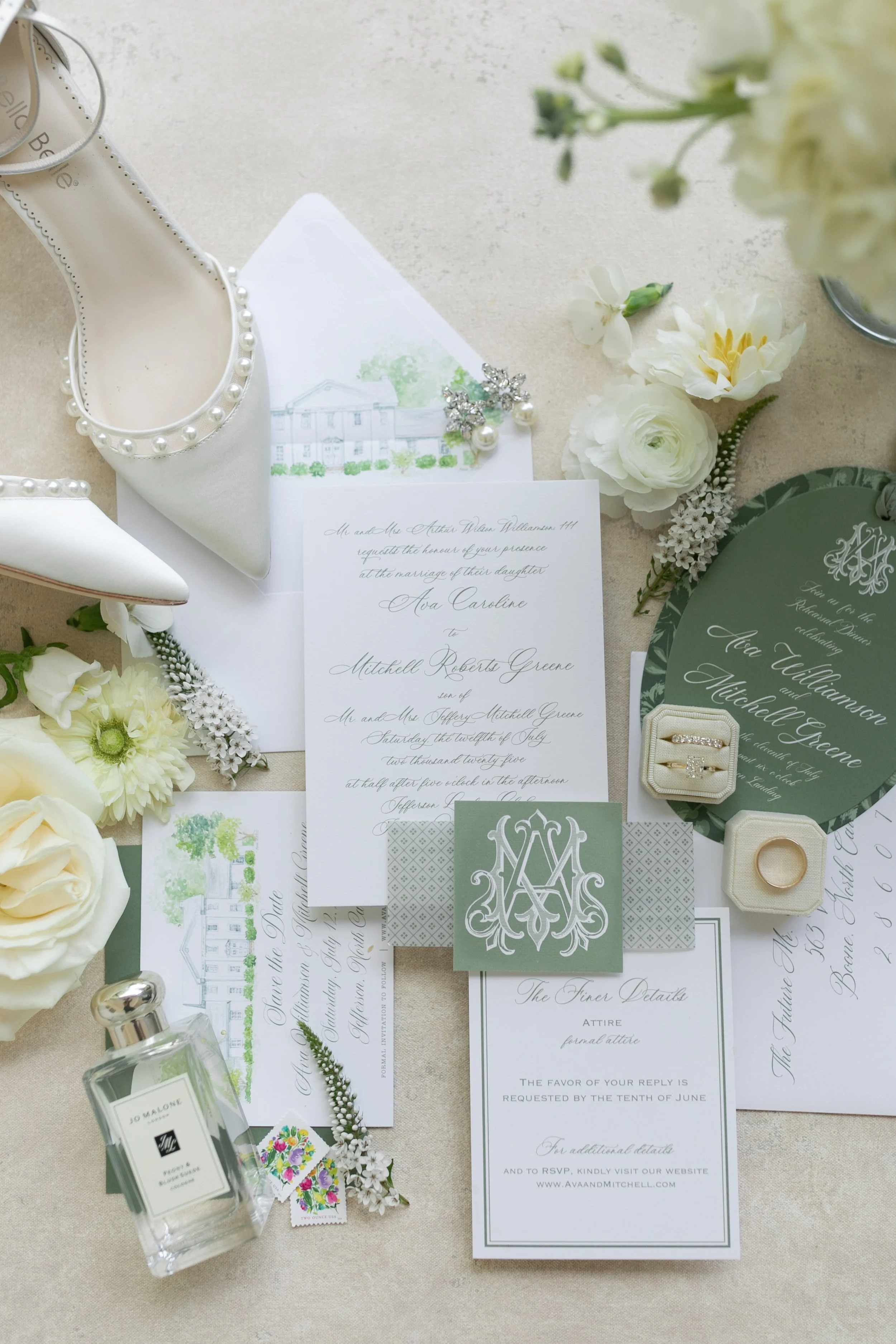 Wedding invitation, white heels with pearl embellishments, white roses, flowers, perfume, jewelry, and wedding details on a beige surface.